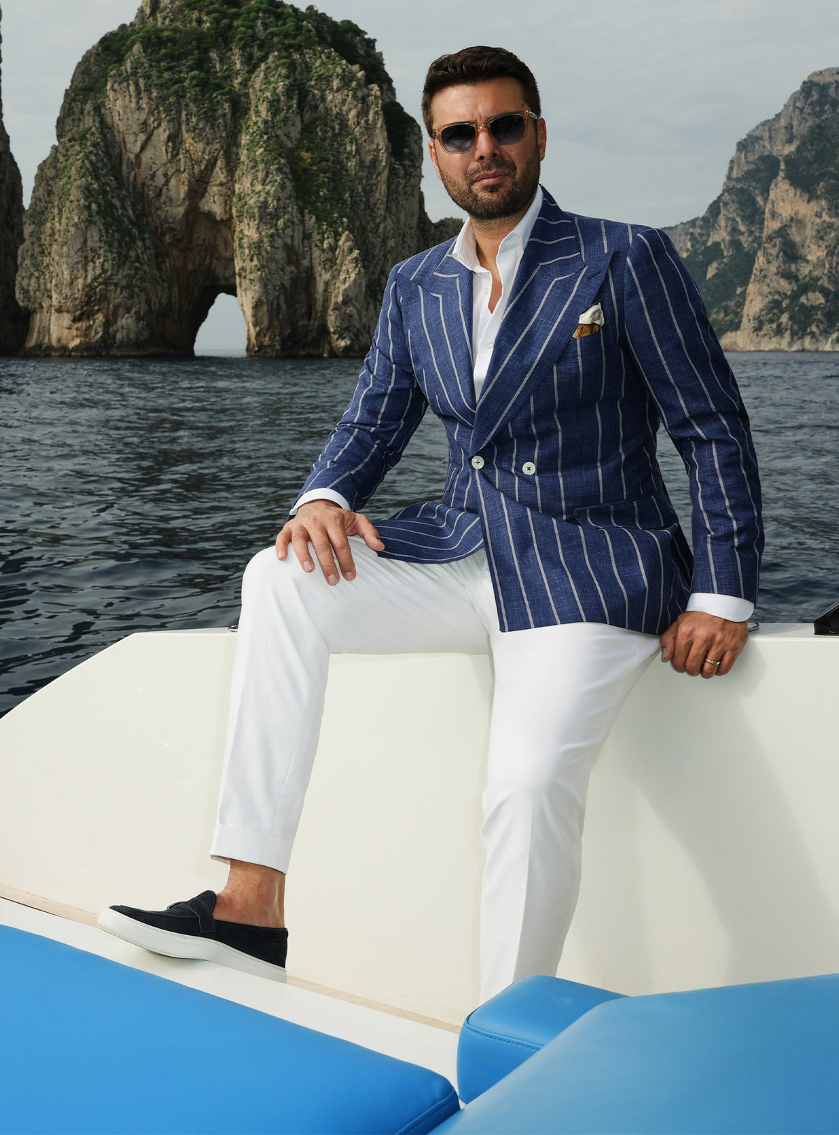 Navy double-breasted Consiglieri blazer with white stripes, worn with white trousers