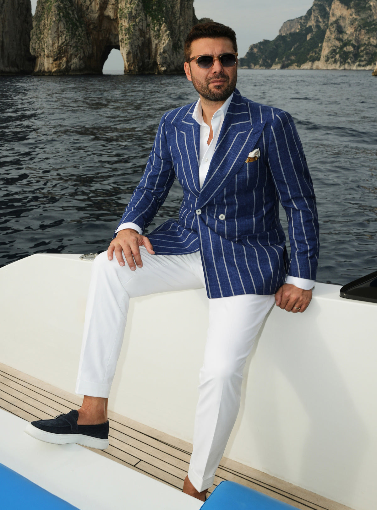 Navy double-breasted Consiglieri blazer with white stripes, worn with white trousers