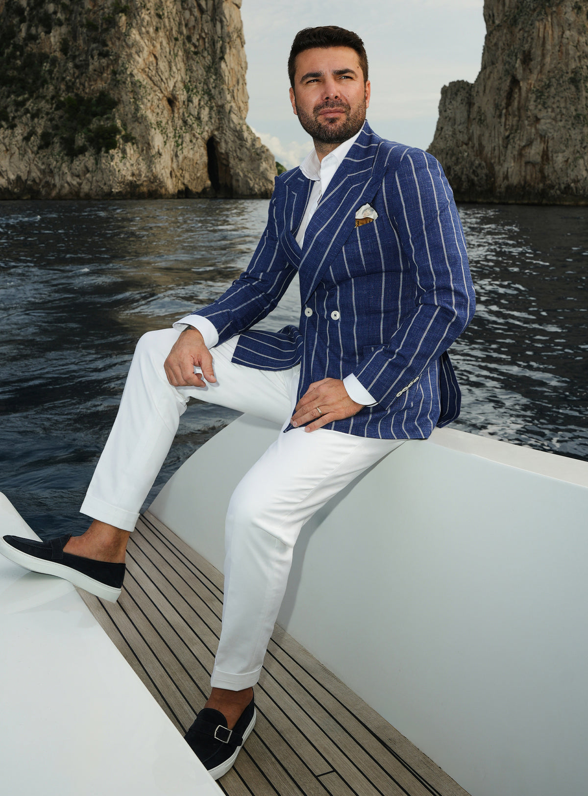 Navy double-breasted Consiglieri blazer with white stripes, worn with white trousers