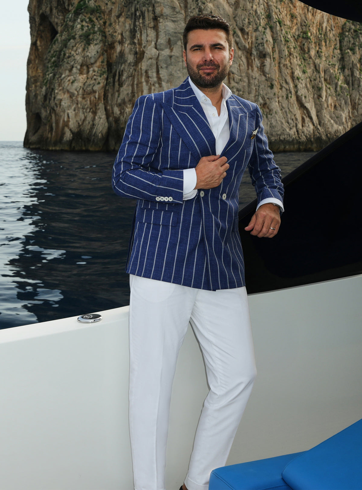 Navy double-breasted Consiglieri blazer with white stripes, worn with white trousers