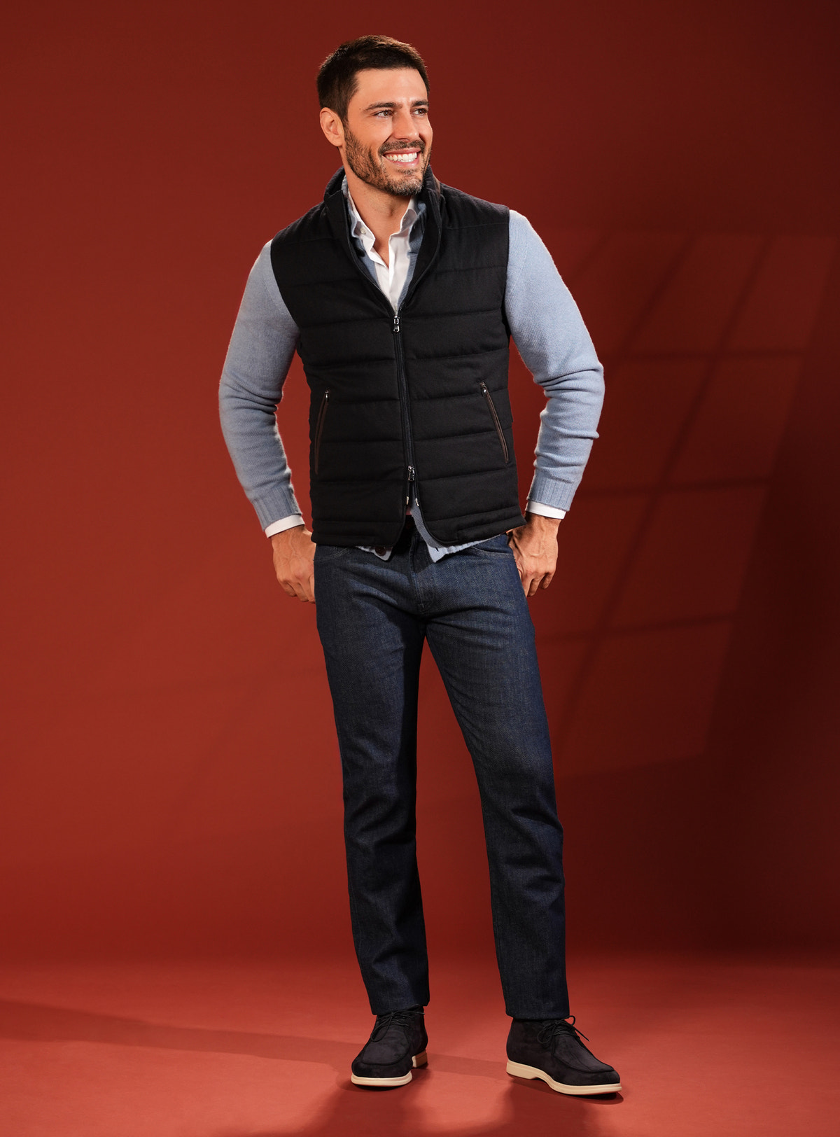 Black quilted Consiglieri vest with a pale blue cardigan and navy jeans