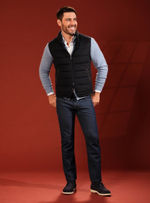 Black quilted Consiglieri vest with a pale blue cardigan and navy jeans
