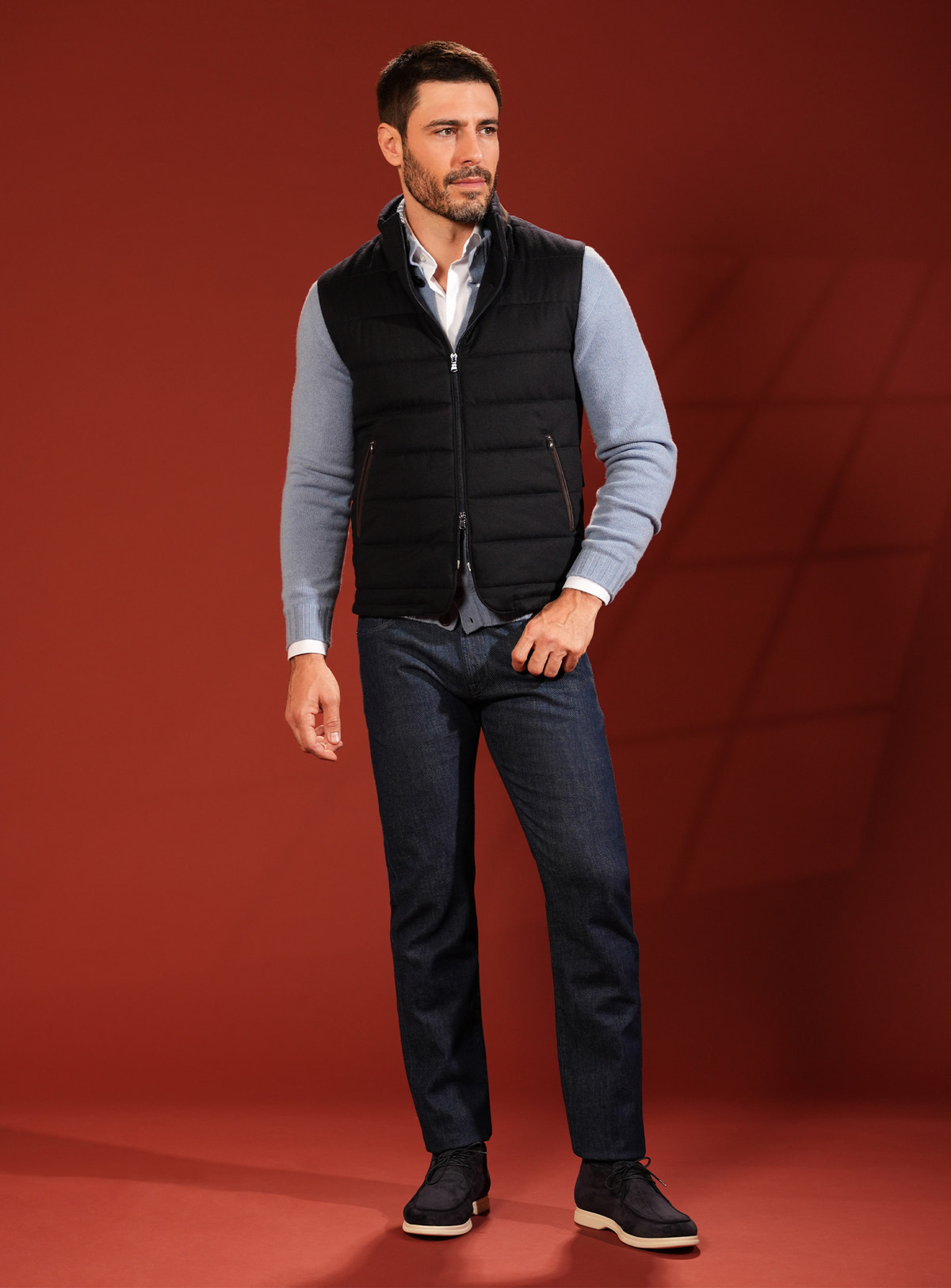 Black quilted Consiglieri vest with a pale blue cardigan and navy jeans