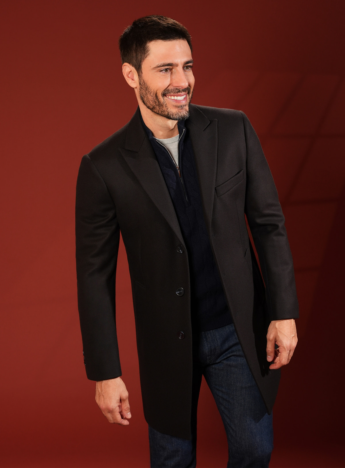 Dark Consiglieri overcoat with classic lapels and a navy shirt
