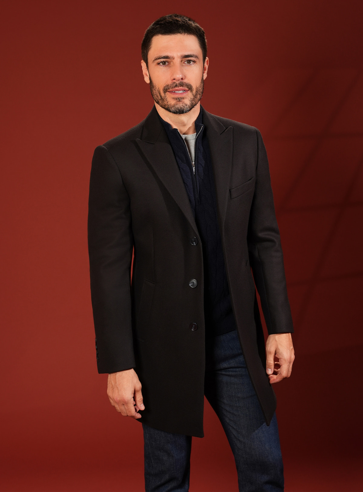 Dark Consiglieri overcoat with classic lapels and a navy shirt