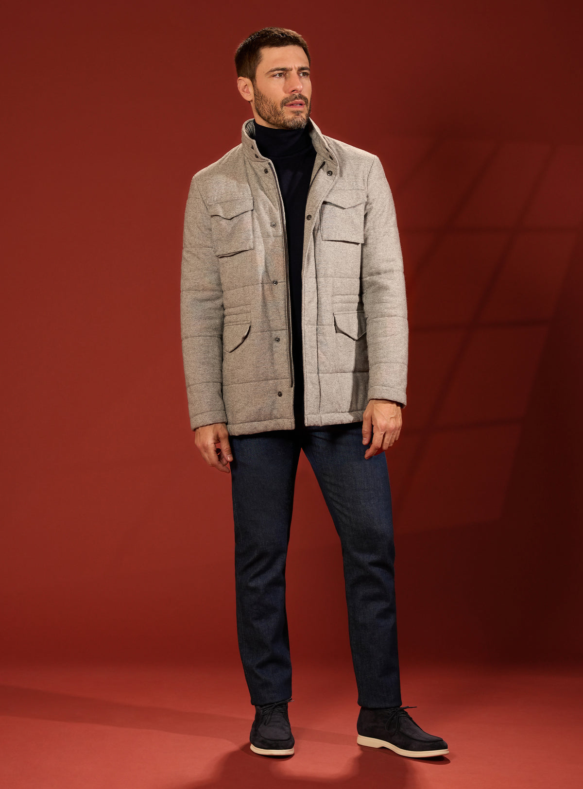 Beige quilted Consiglieri jacket worn with navy trousers