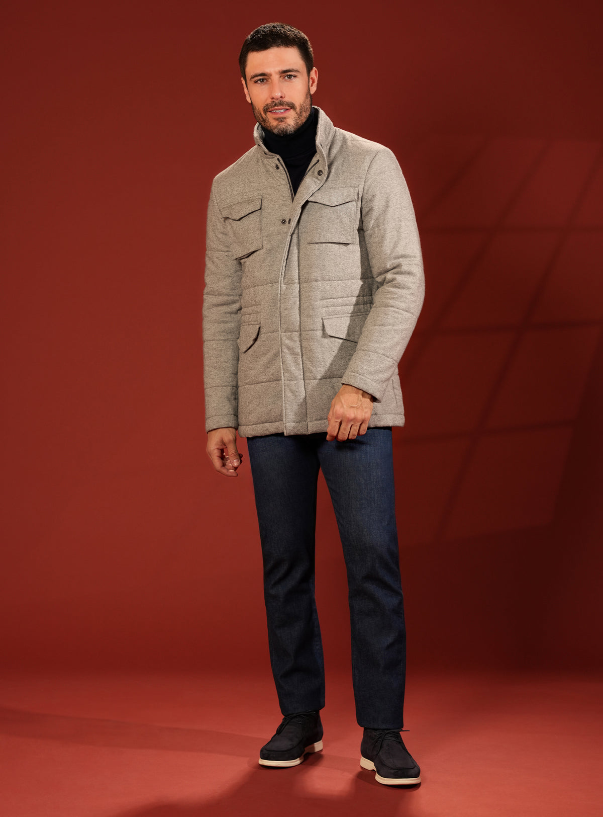 Beige quilted Consiglieri jacket worn with navy trousers