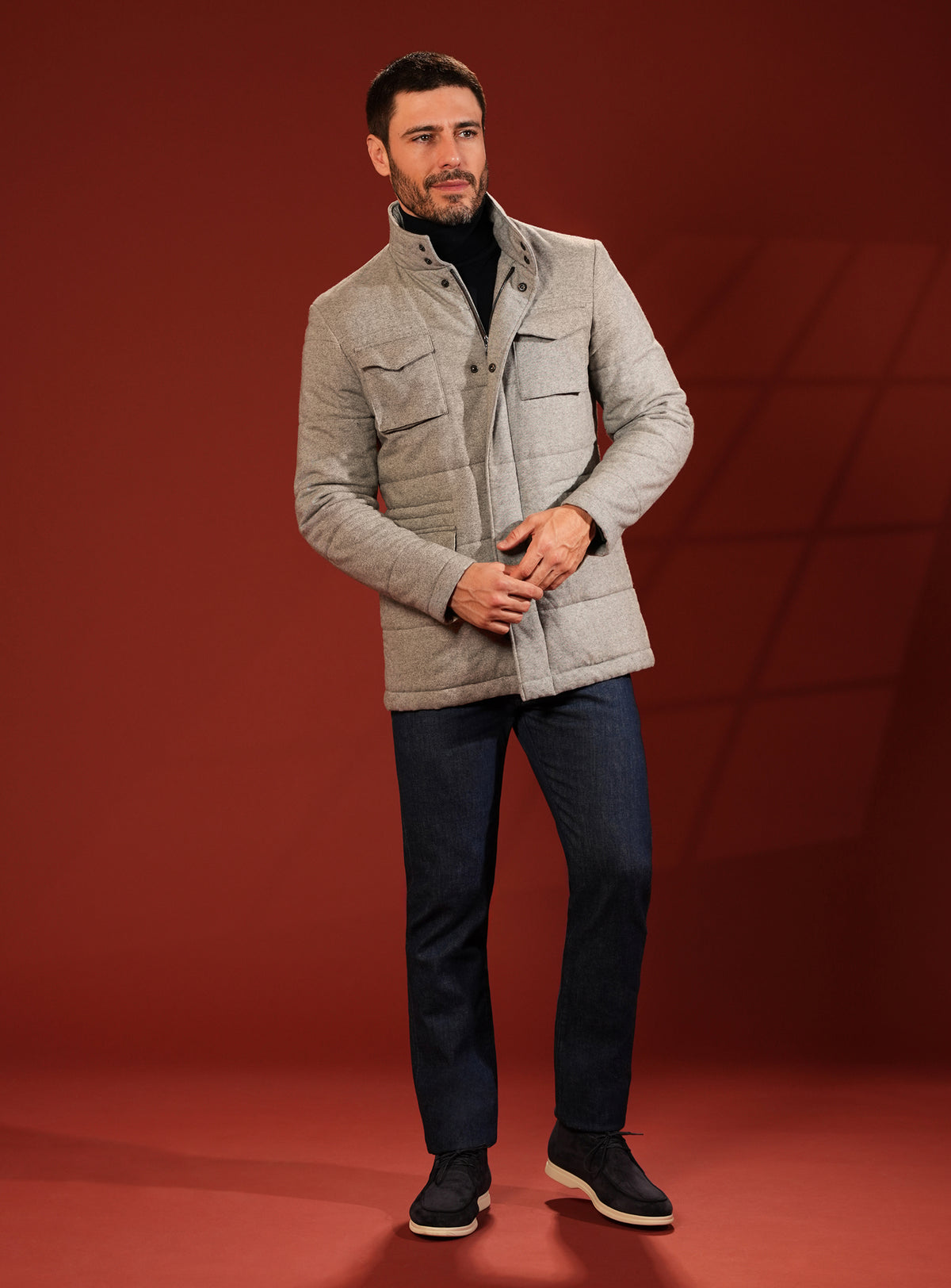 Beige quilted Consiglieri jacket worn with navy trousers