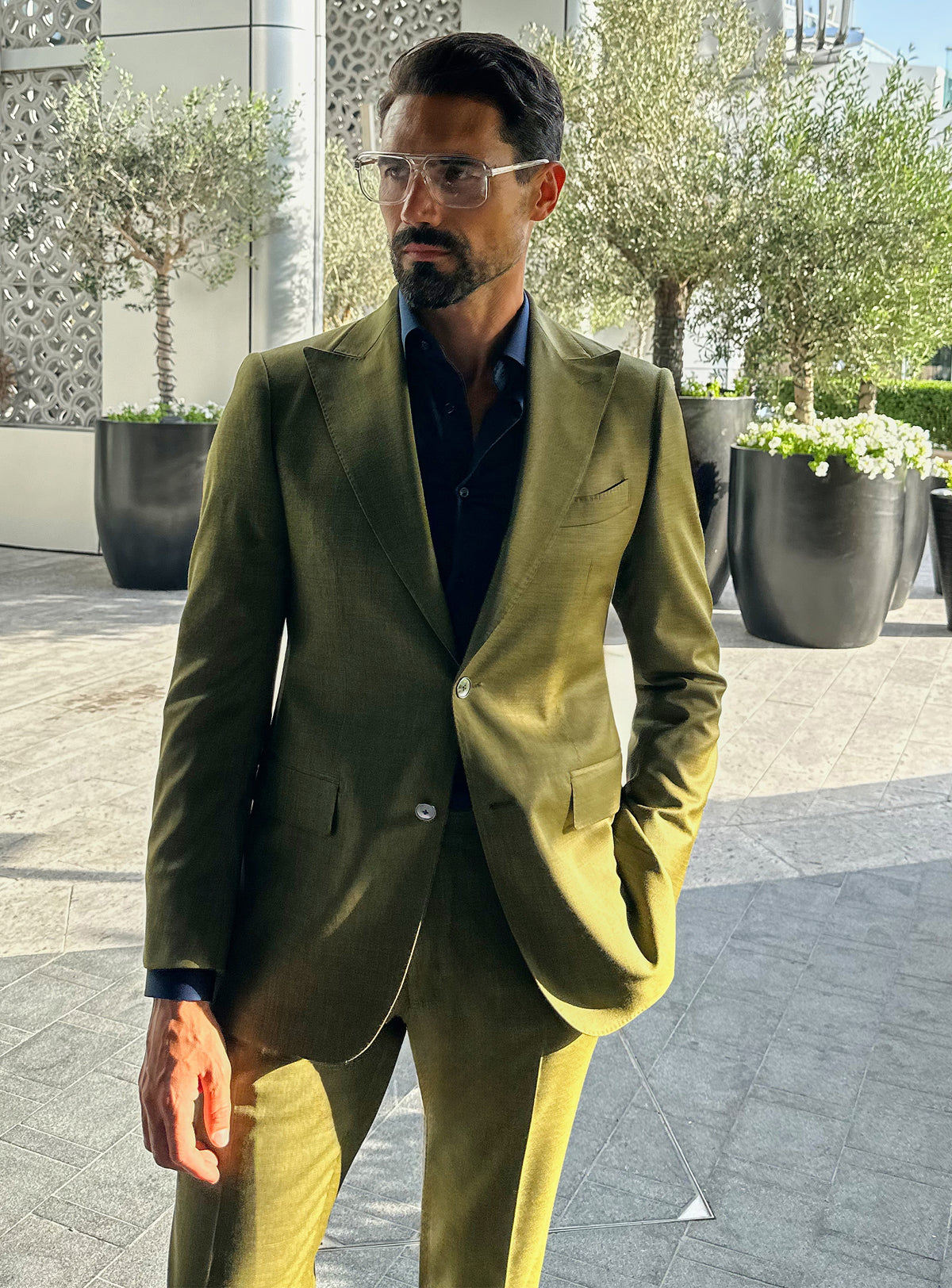 Olive green Consiglieri jacket with a dark shirt and elongated lapels