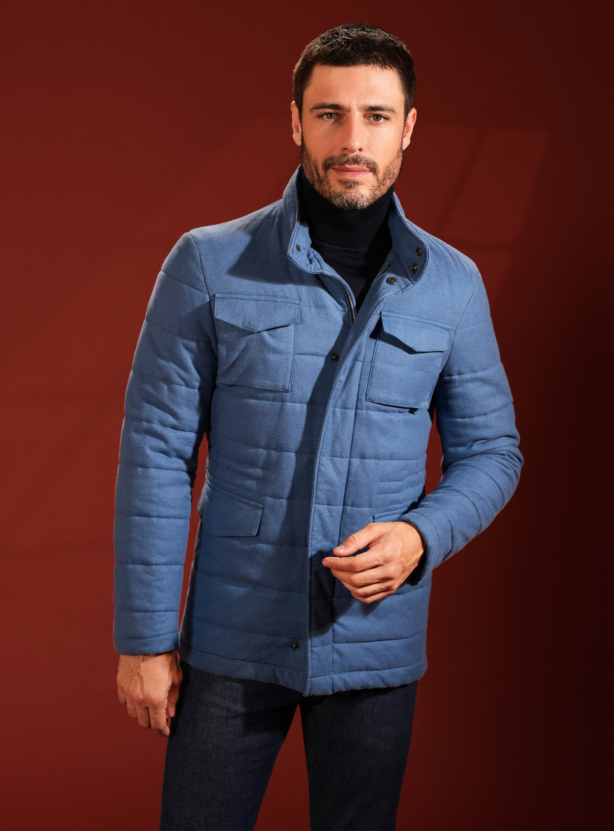 Blue quilted Consiglieri jacket with patch pockets and a navy turtleneck