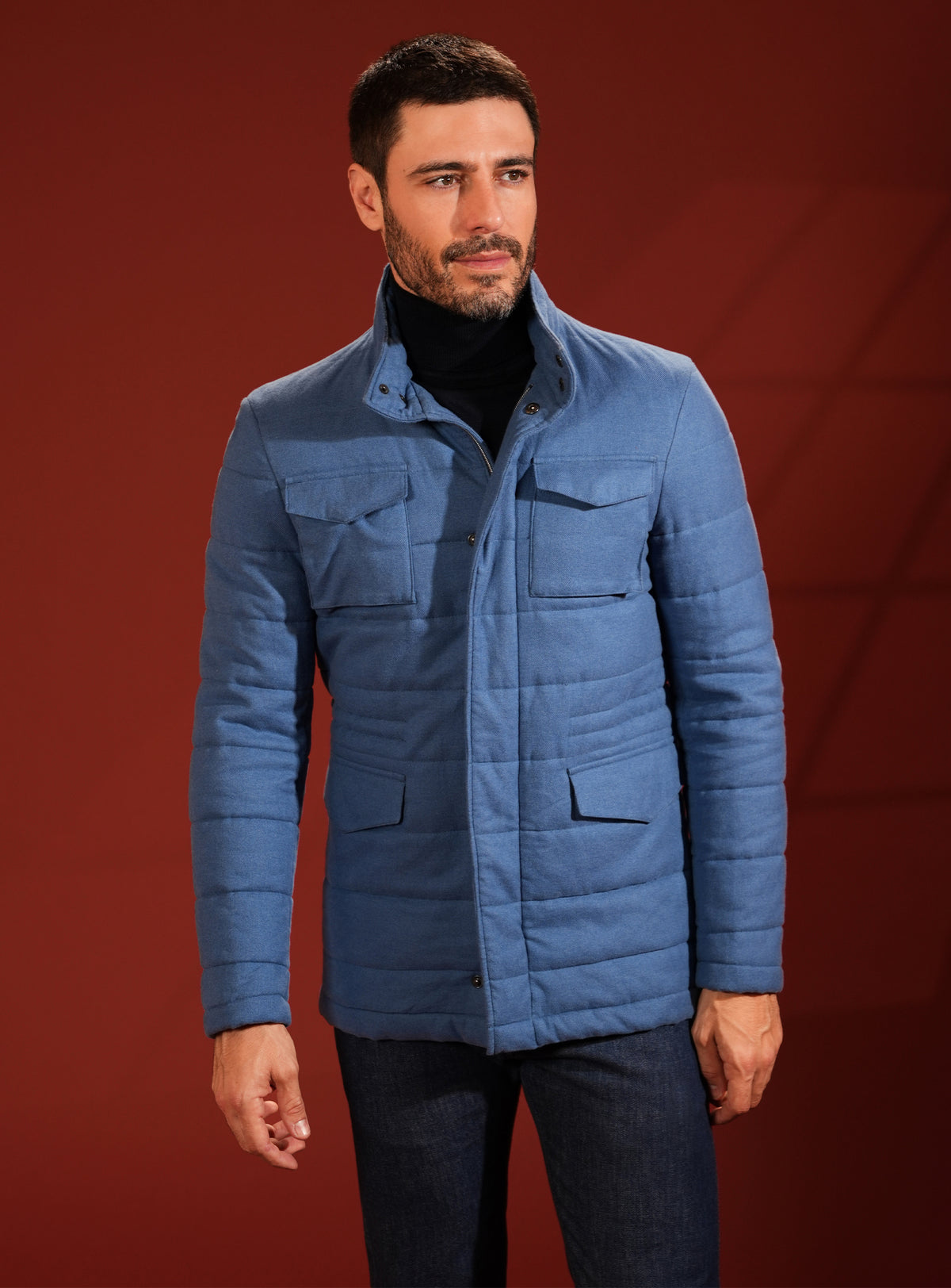 Blue quilted Consiglieri jacket with patch pockets and a navy turtleneck