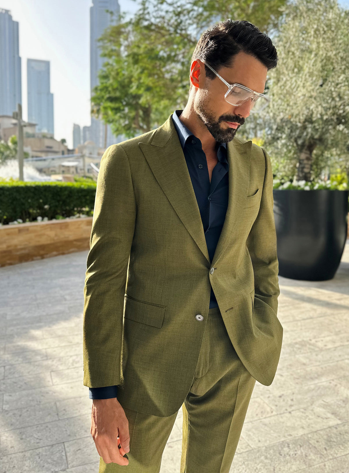 Olive green Consiglieri jacket with a dark shirt and elongated lapels