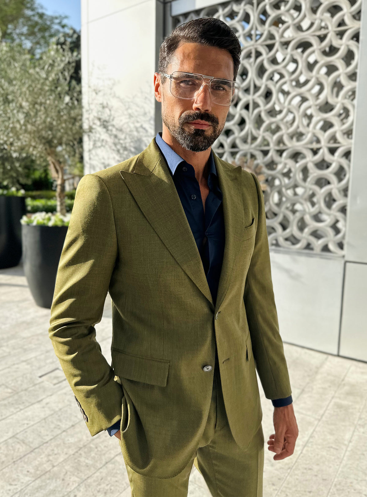 Olive green Consiglieri jacket with a dark shirt and elongated lapels