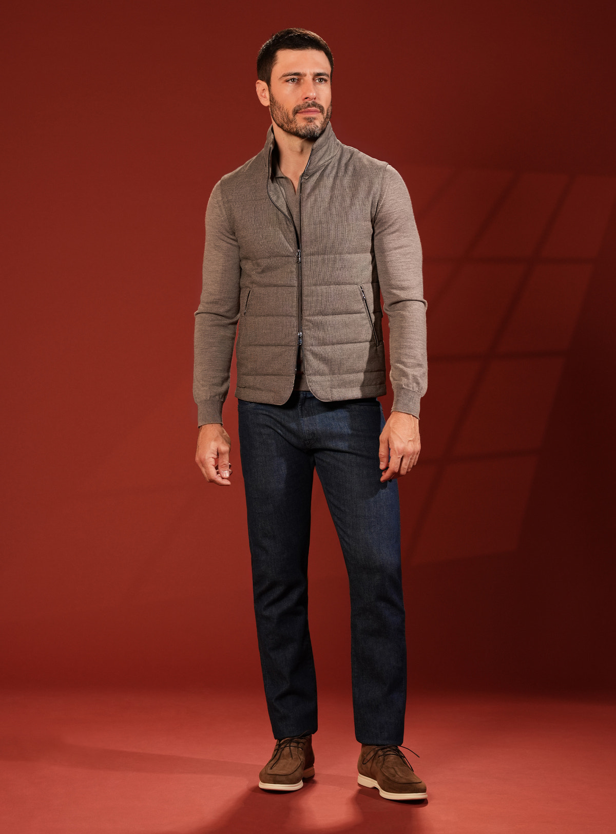 Taupe grey quilted Consiglieri vest with a coordinated shirt and navy jeans