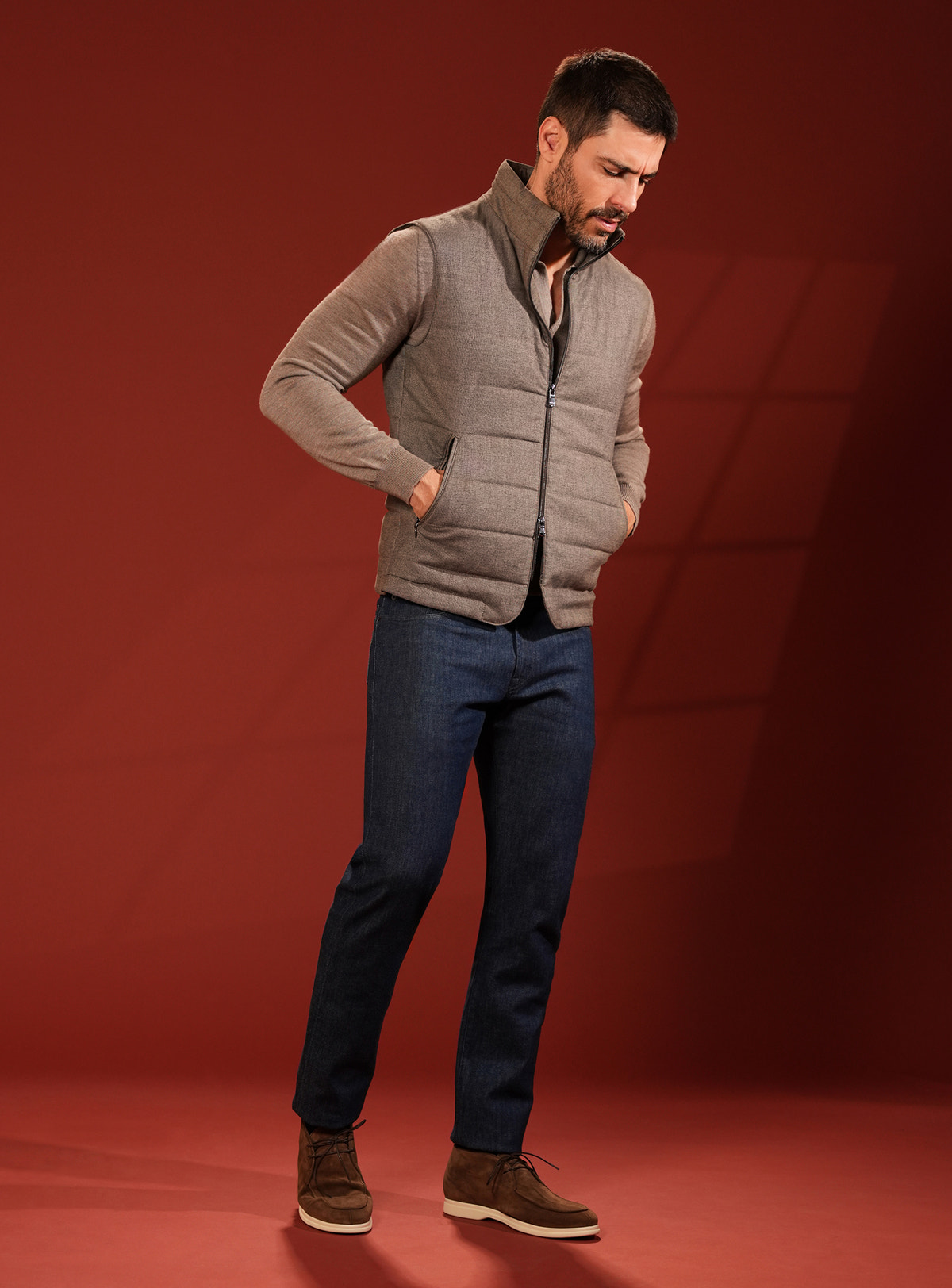 Taupe grey quilted Consiglieri vest with a coordinated shirt and navy jeans
