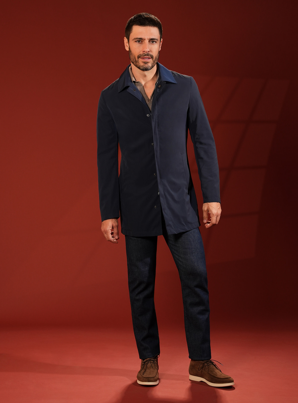 Navy Consiglieri short coat in a look with dark trousers and brown shoes