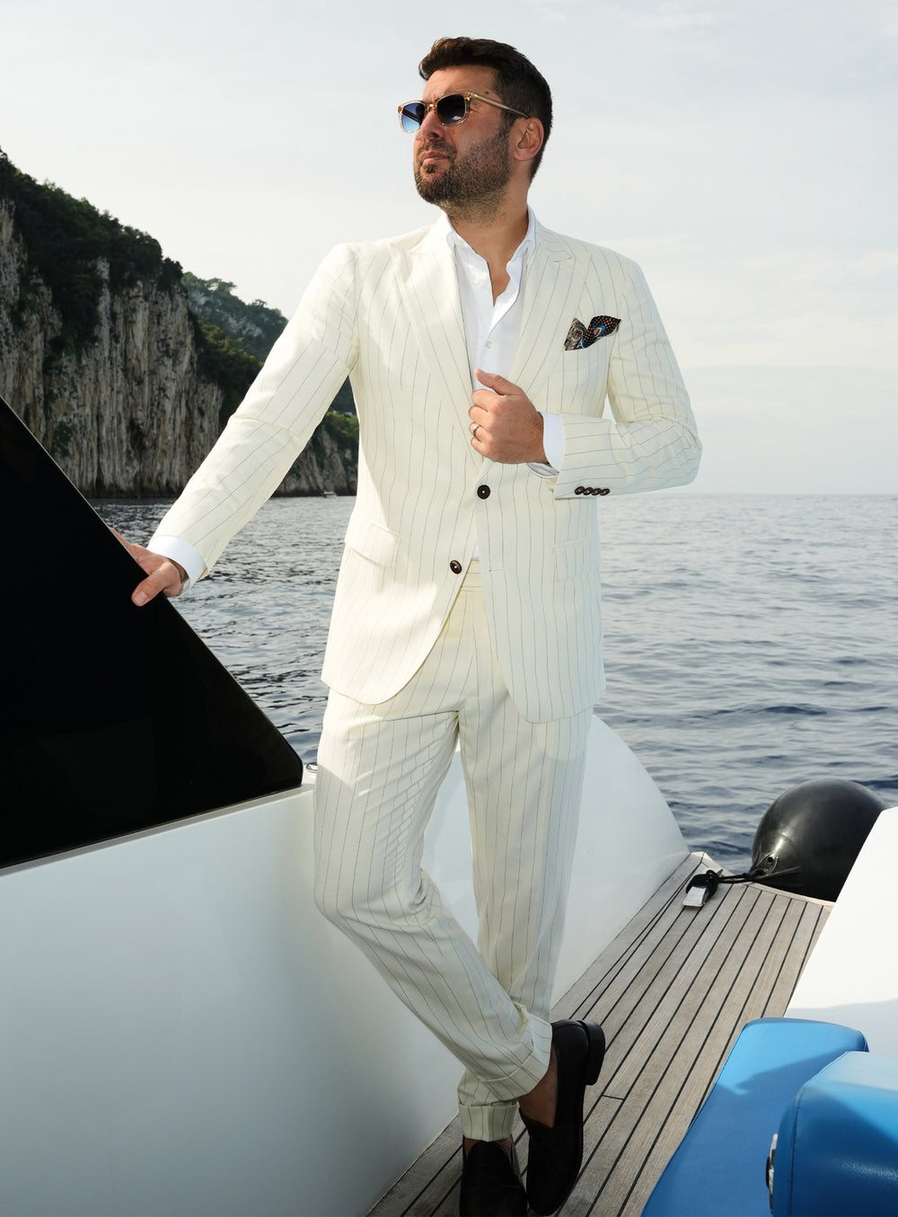 Ivory pinstriped Consiglieri suit worn with a white shirt and dark pocket square