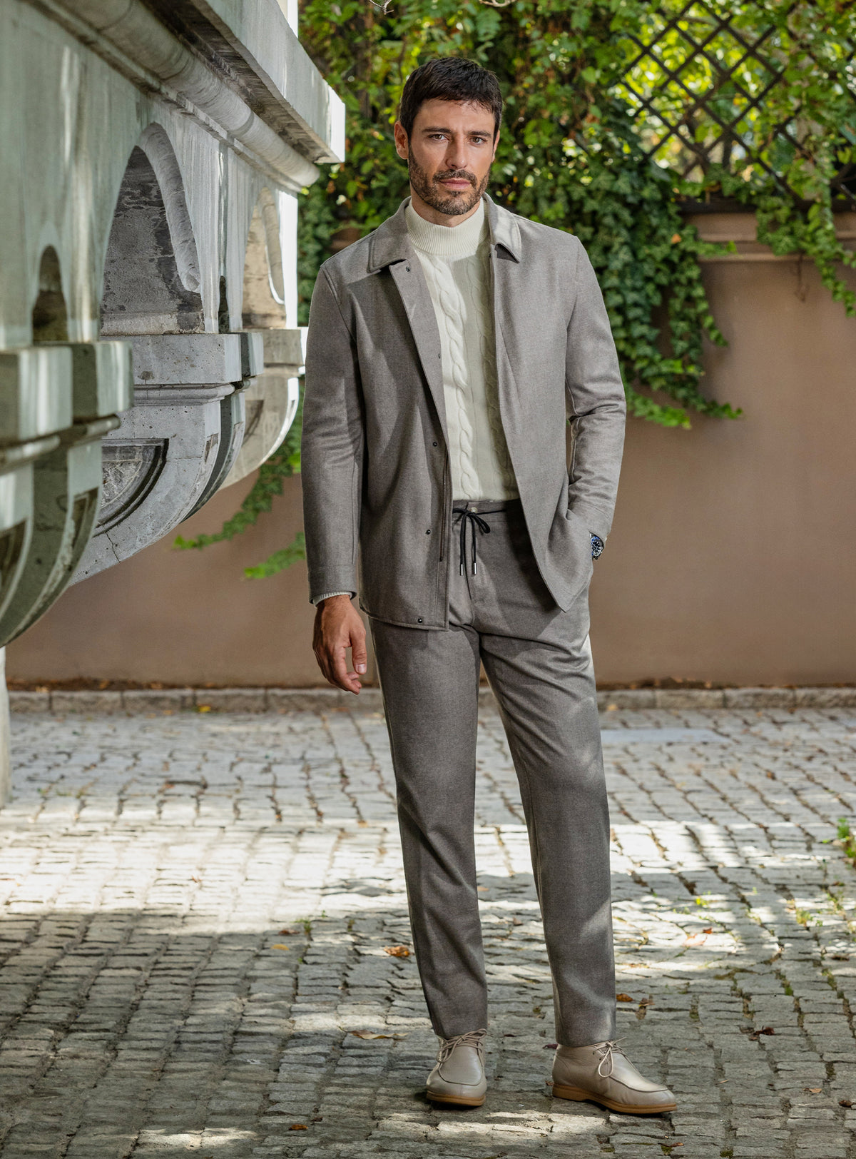 Consiglieri: taupe-grey jacket and trouser ensemble with an ivory roll-neck