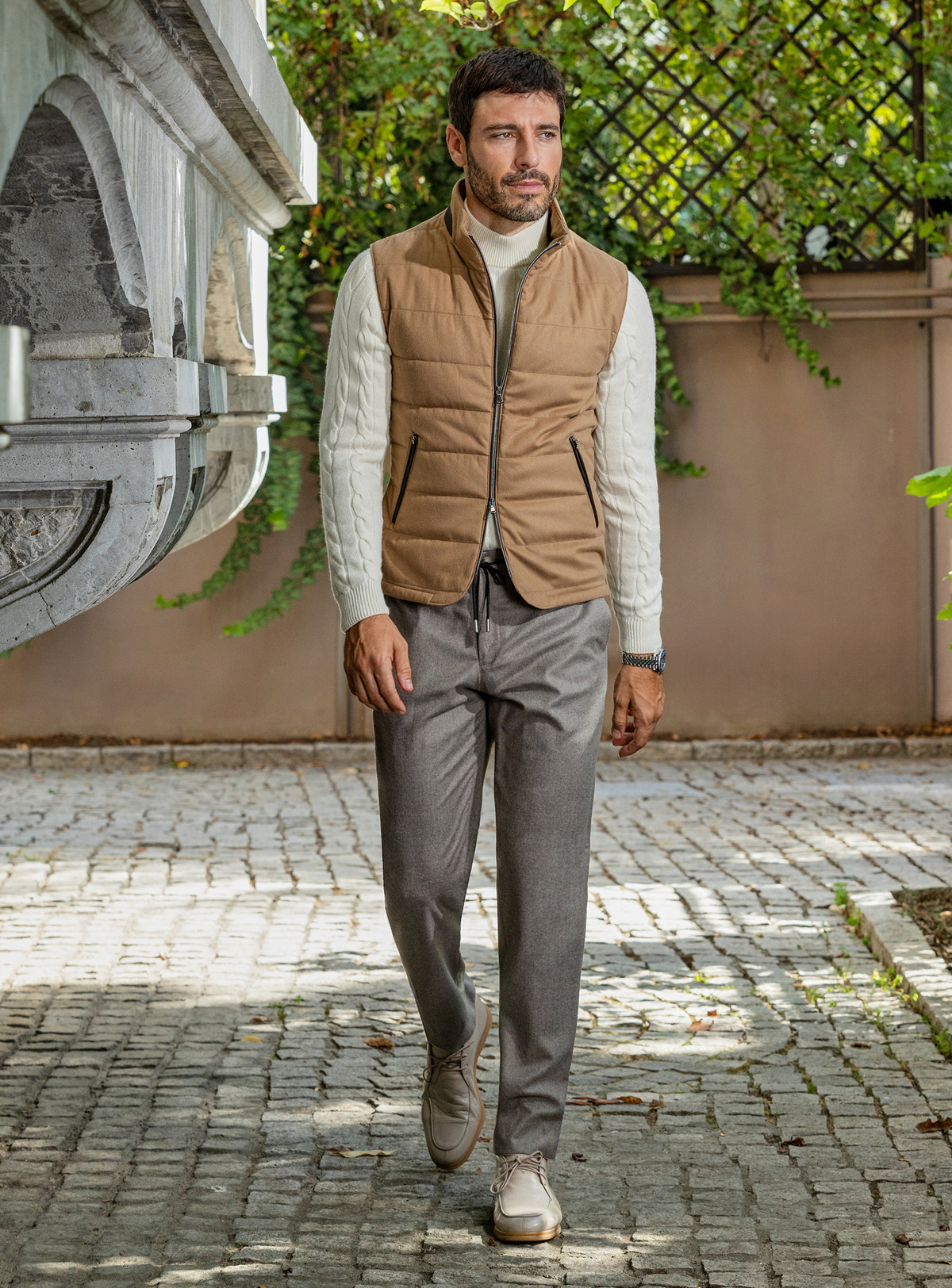 Consiglieri: camel quilted gilet with an ivory sweater and grey trousers