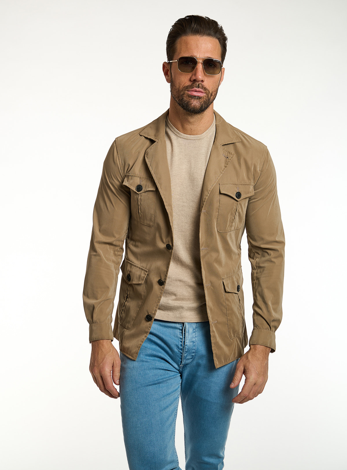 Consiglieri: beige T-shirt beneath a camel jacket with patch pockets
