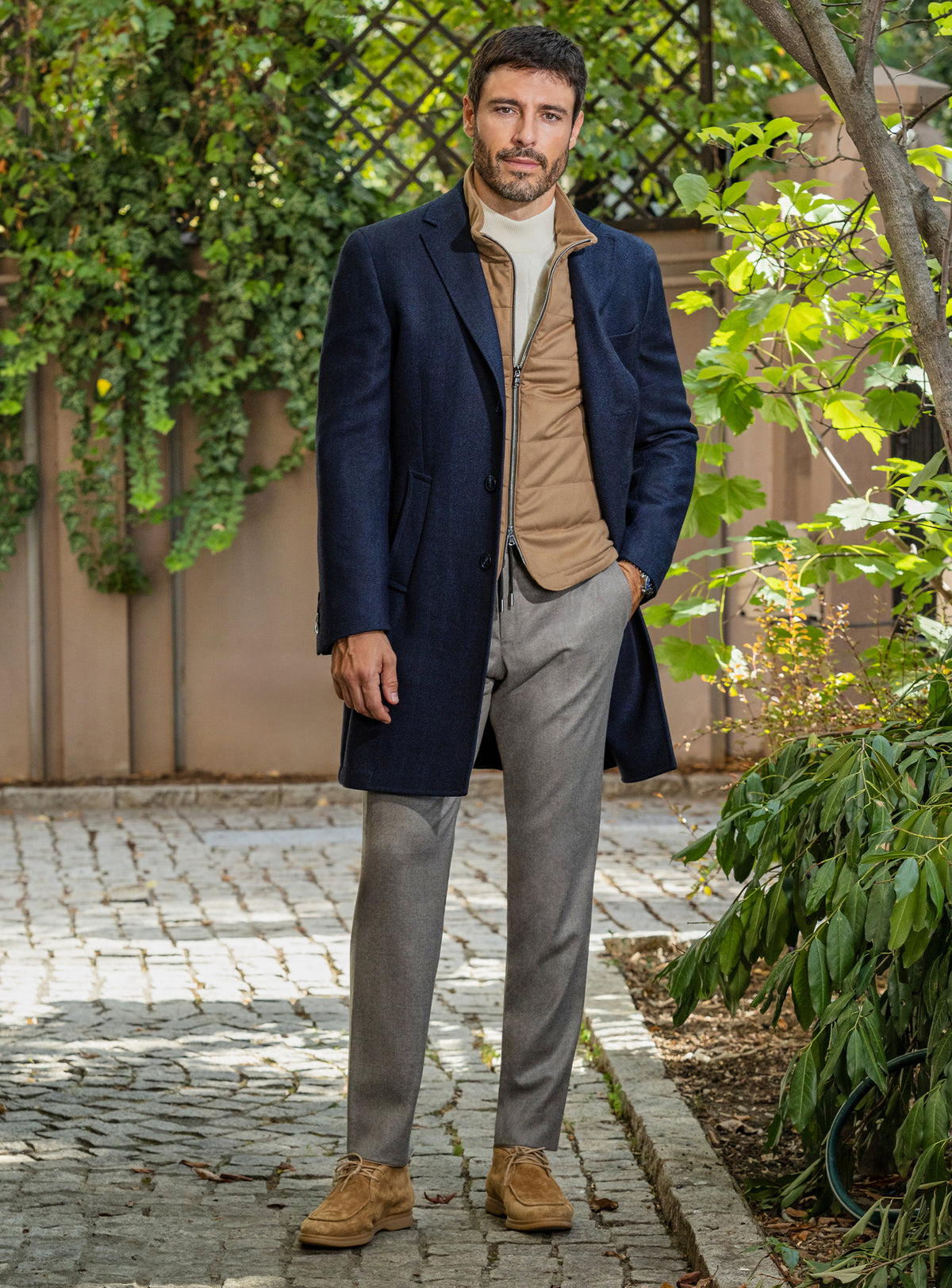 Consiglieri: navy overcoat over a camel gilet, with grey trousers