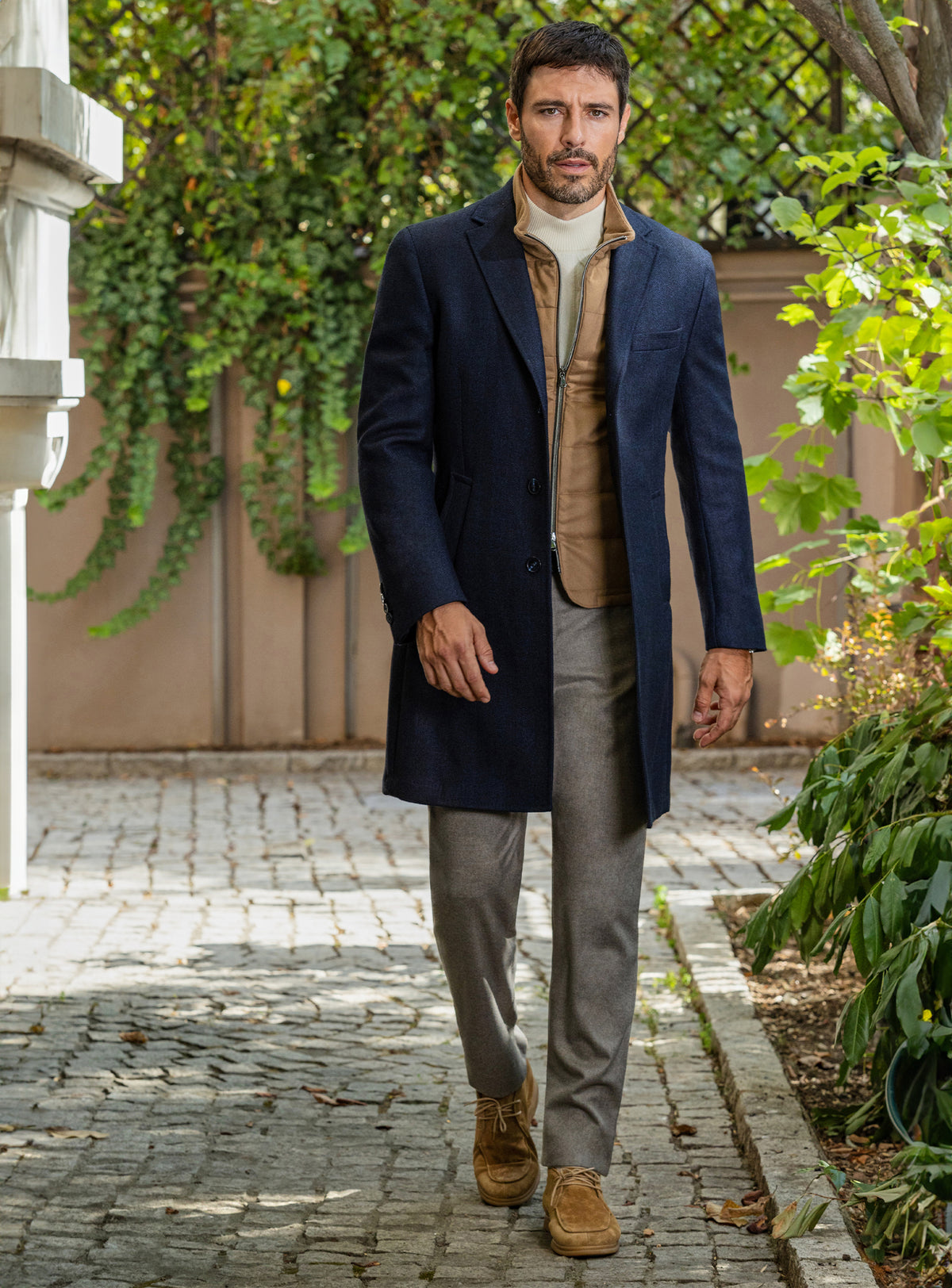 Consiglieri: navy overcoat over a camel gilet, with grey trousers