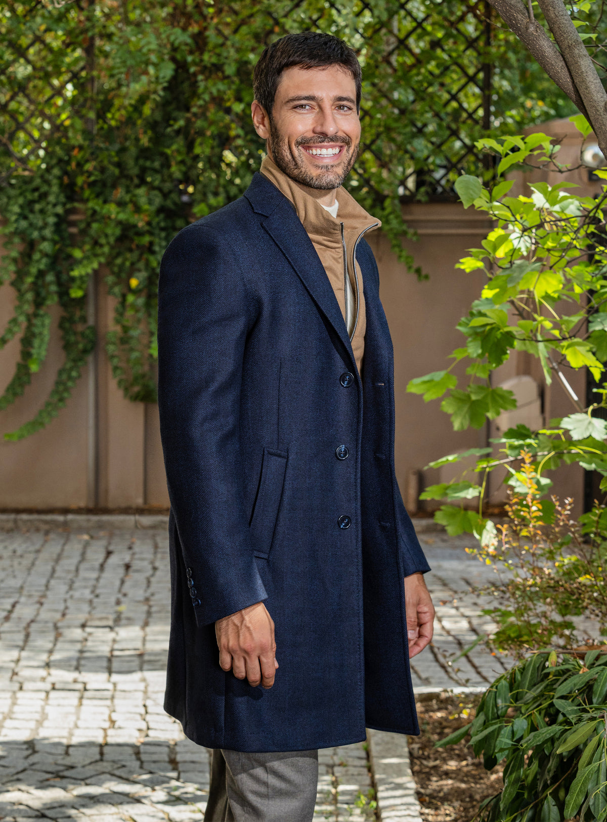 Consiglieri: navy overcoat over a camel gilet, with grey trousers