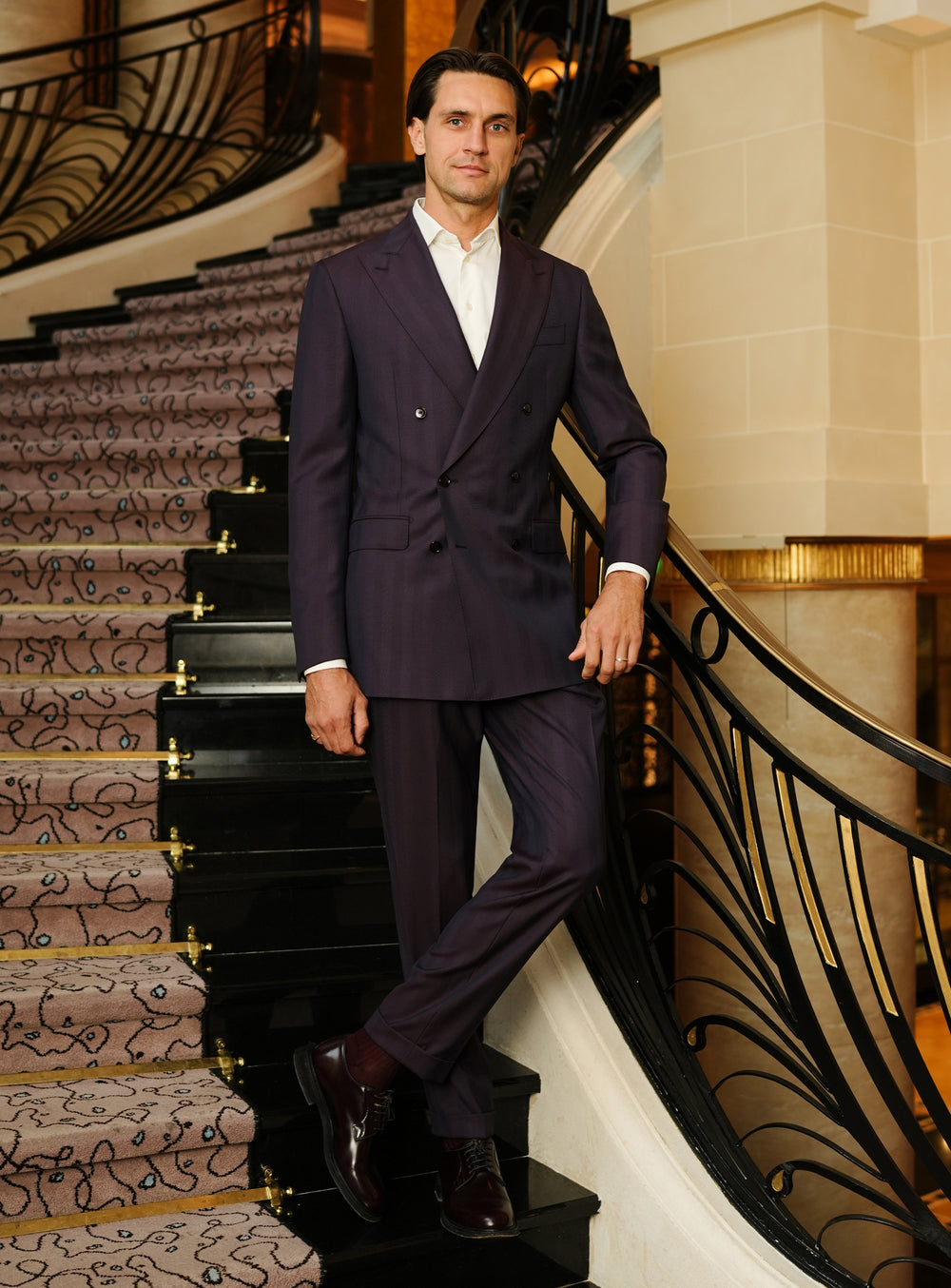 Plum-toned Consiglieri suit with a double-breasted jacket and white shirt