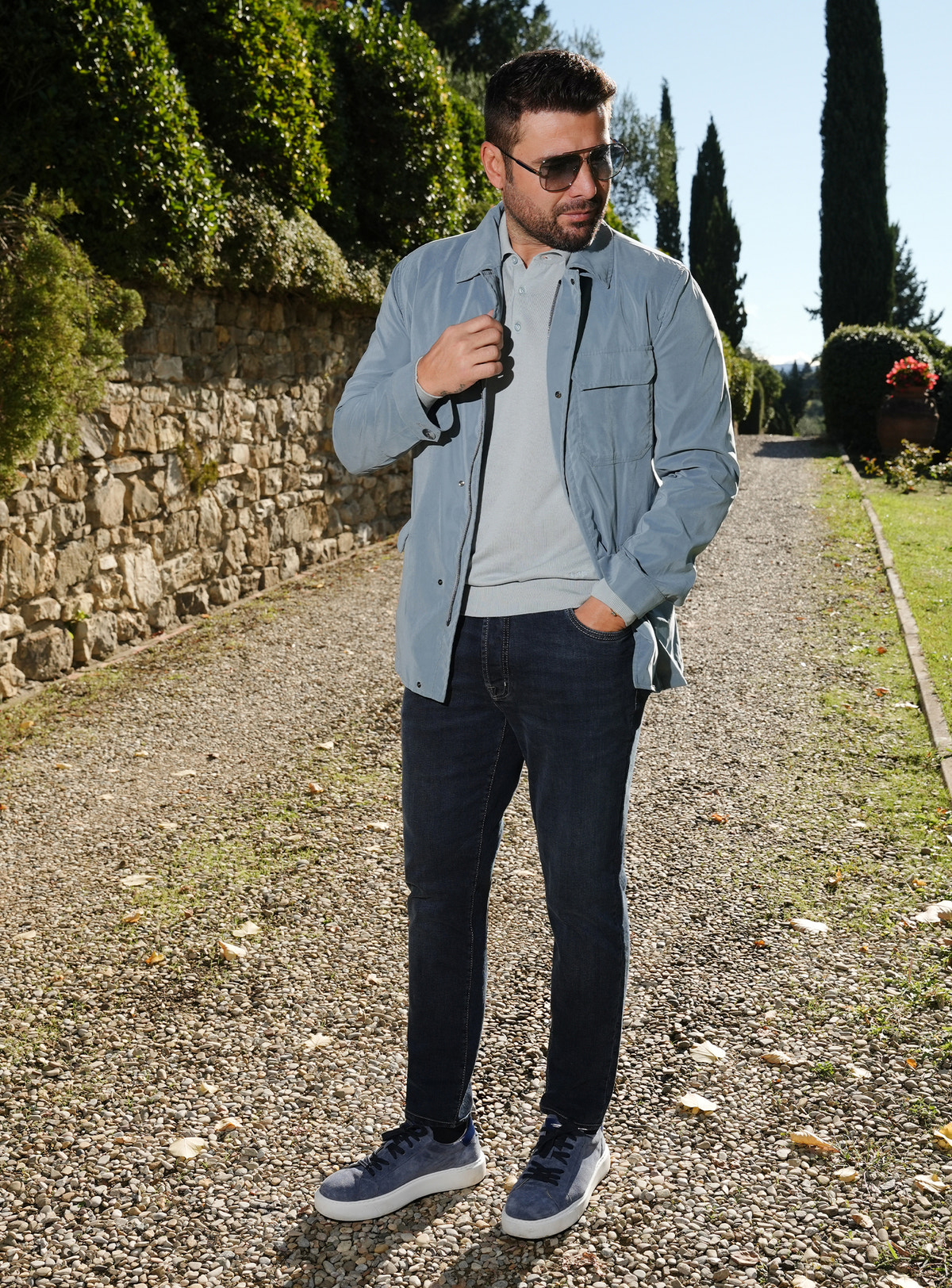 Navy Consiglieri jeans worn with a pale blue jacket and sneakers