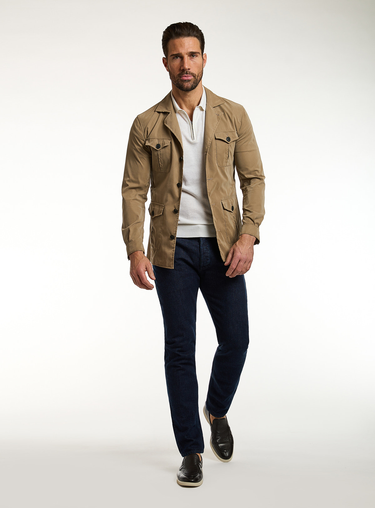 Consiglieri: dark jeans with a camel jacket and ivory polo