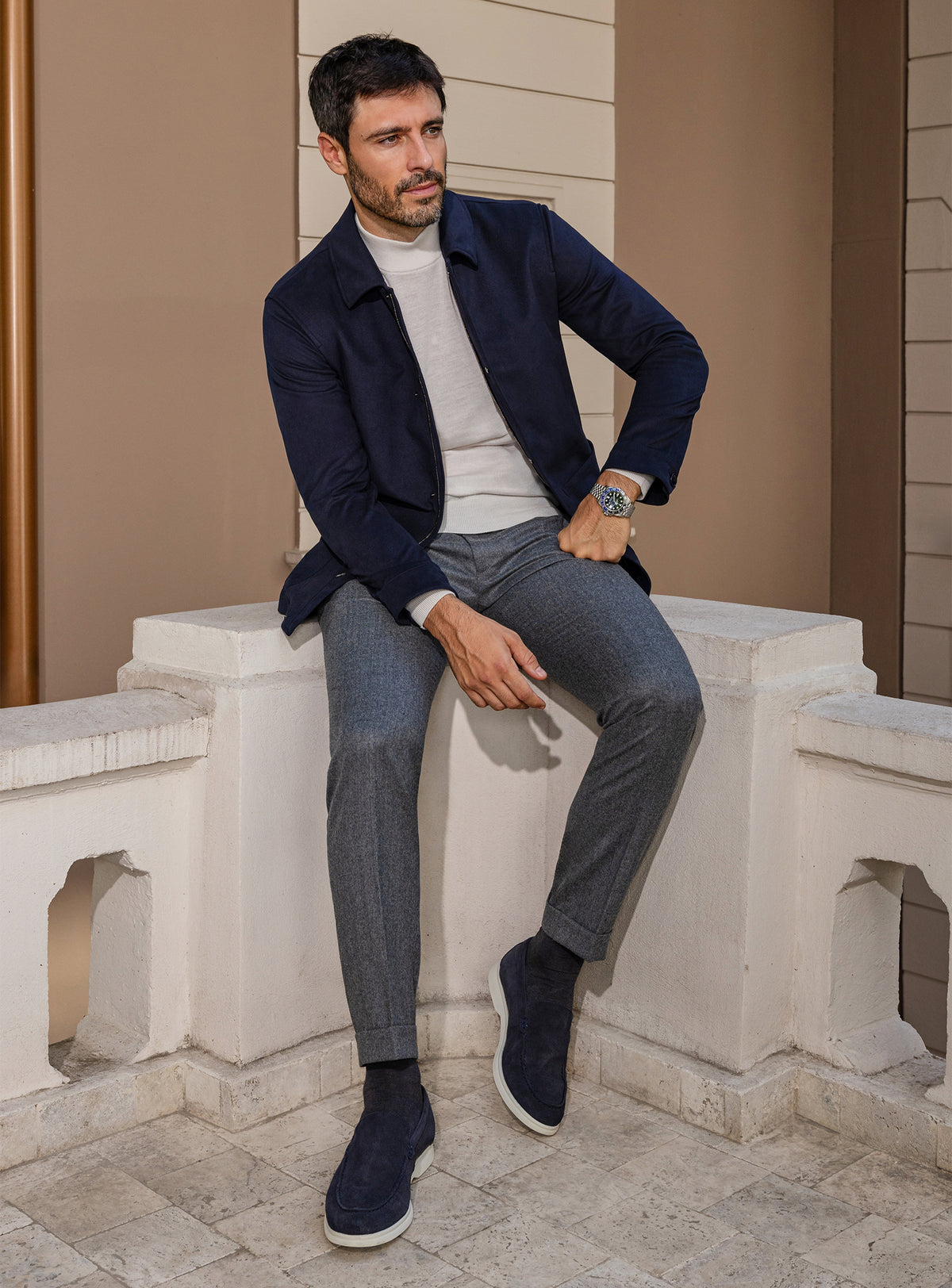 Consiglieri: navy jacket with an ivory roll-neck and grey trousers