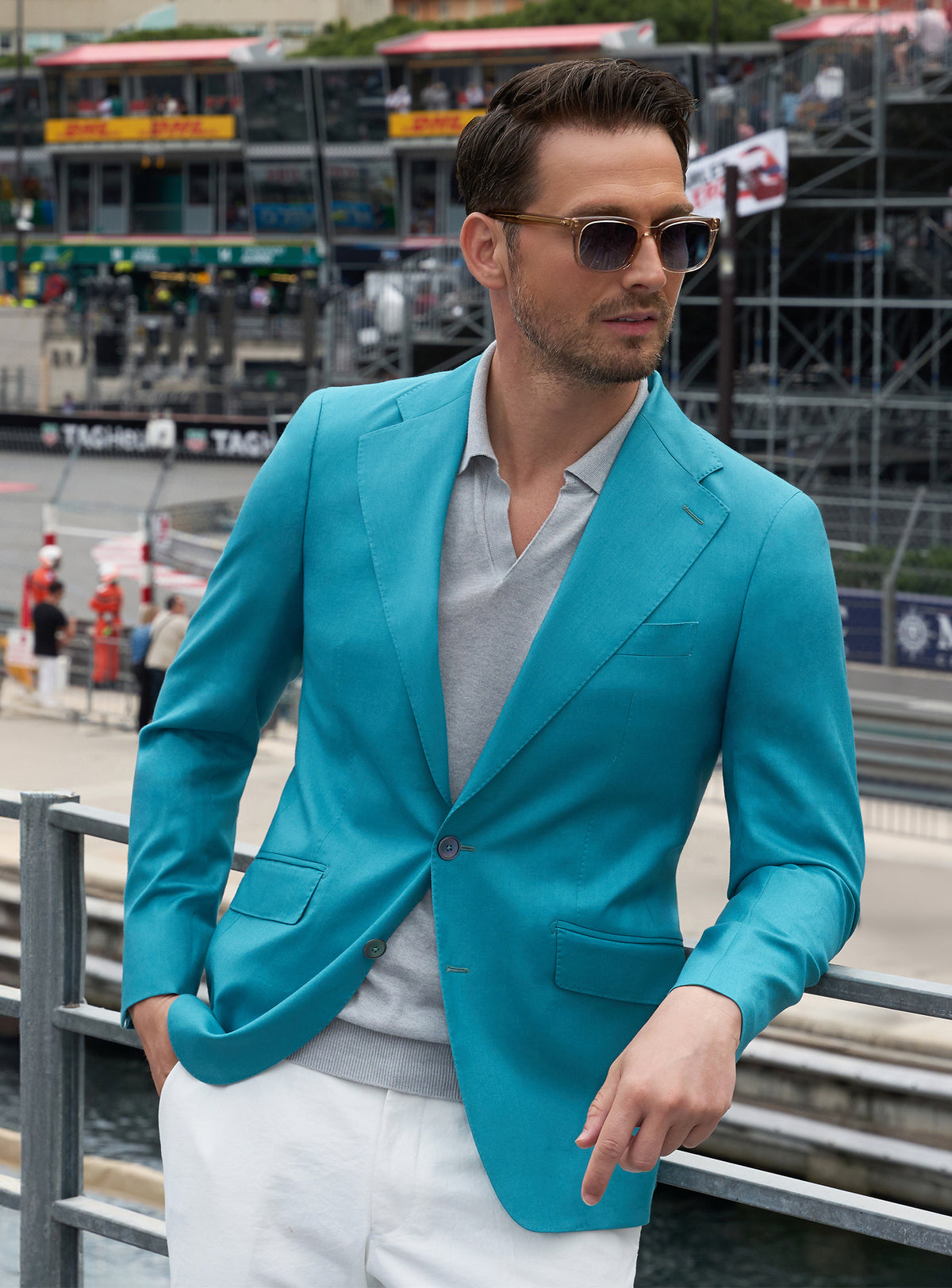 Turquoise Consiglieri jacket worn with a white shirt and ivory trousers