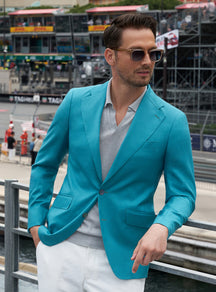 Turquoise Consiglieri jacket worn with a white shirt and ivory trousers