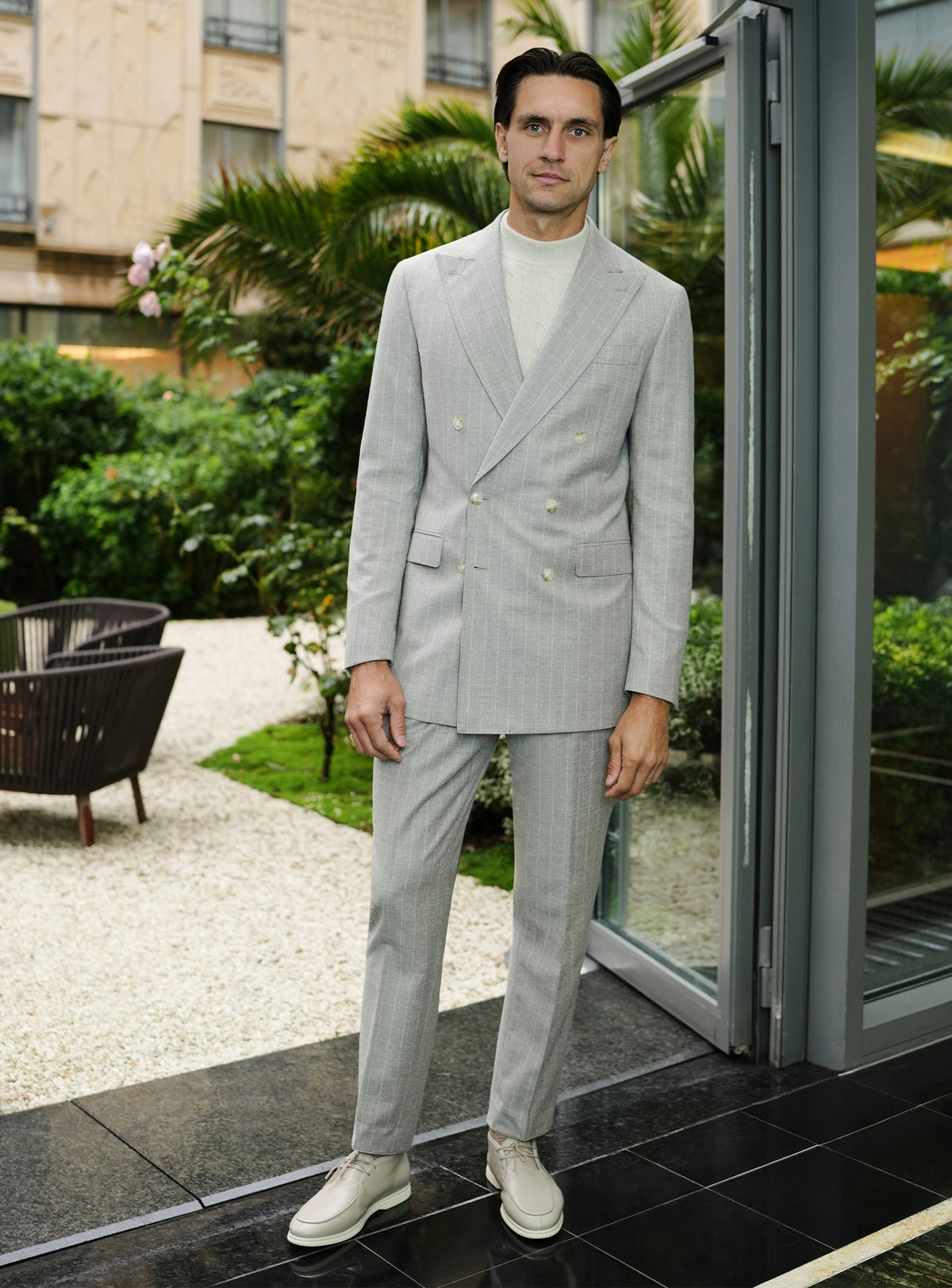 Light grey Consiglieri suit with a double-breasted jacket and ivory turtleneck