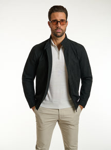 Consiglieri: dark green zip-front jacket with an ivory polo and beige trousers