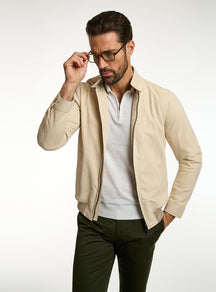 Consiglieri: cream zip-front jacket with an ivory polo and green trousers