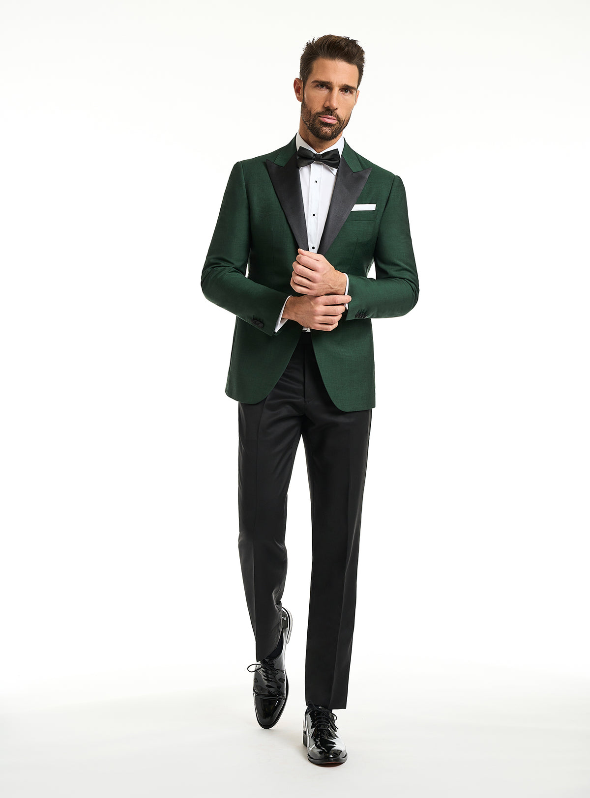 Consiglieri: emerald green tuxedo jacket with black lapels and black trousers