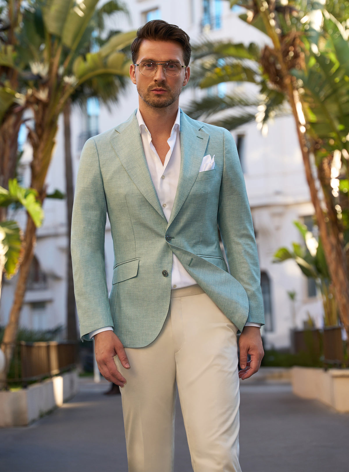 Mint green Consiglieri jacket with a white shirt and ivory trousers