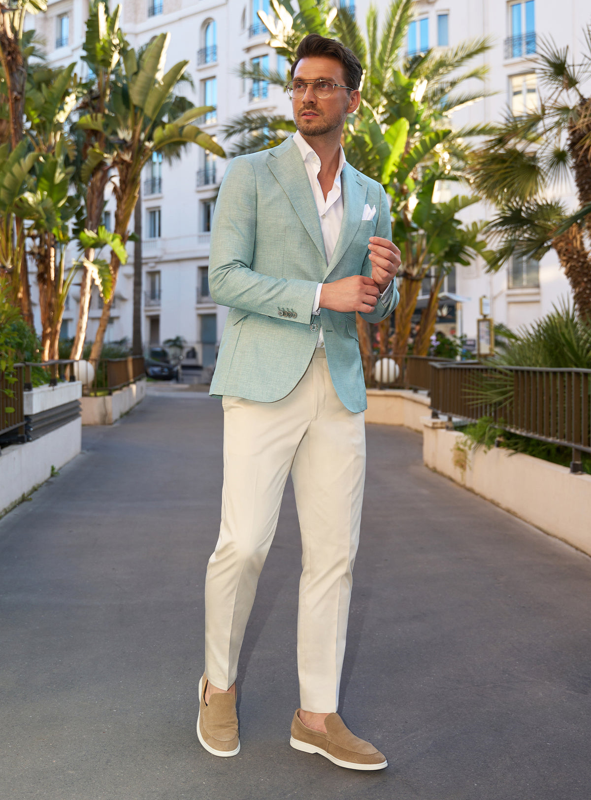 Consiglieri look with a mint green jacket, ivory trousers and beige loafers