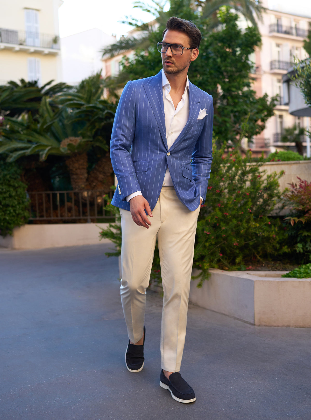 Blue pinstripe jacket in a look with beige trousers and dark loafers