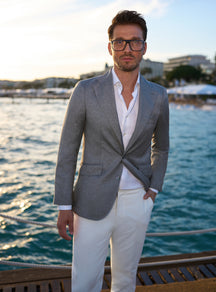 Grey Consiglieri jacket worn with an open-collar white shirt
