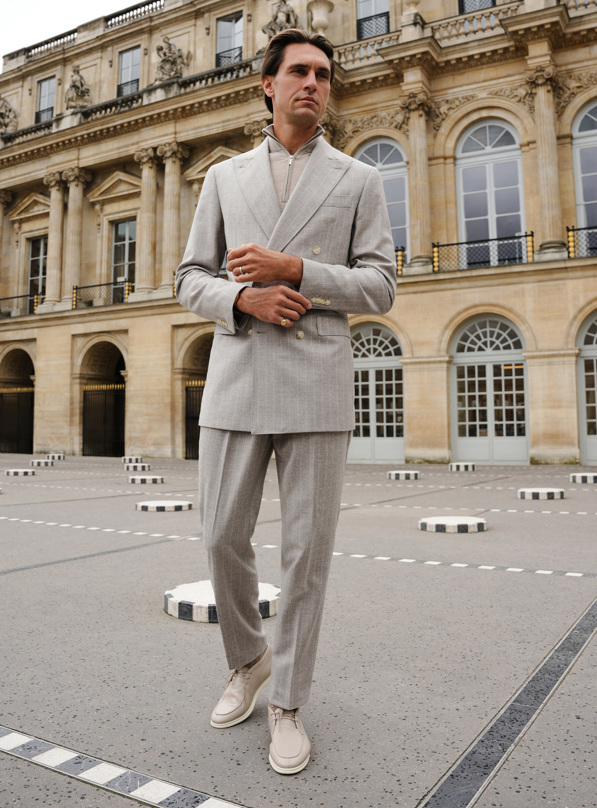 Light grey Consiglieri suit with a double-breasted jacket and ivory turtleneck