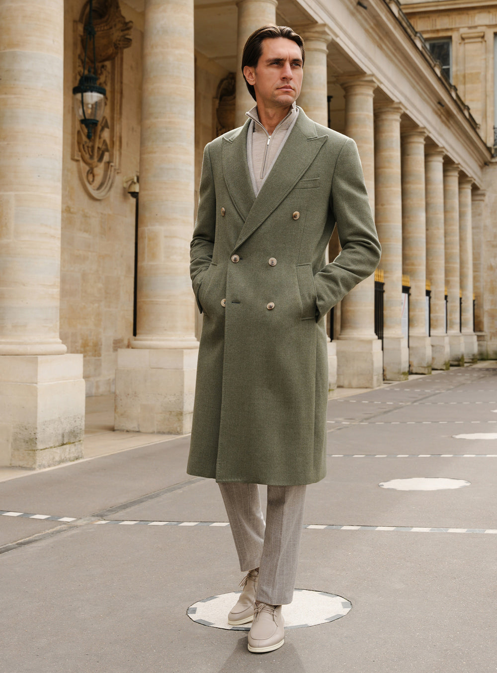 Long olive green Consiglieri overcoat with a double-breasted front and light trousers