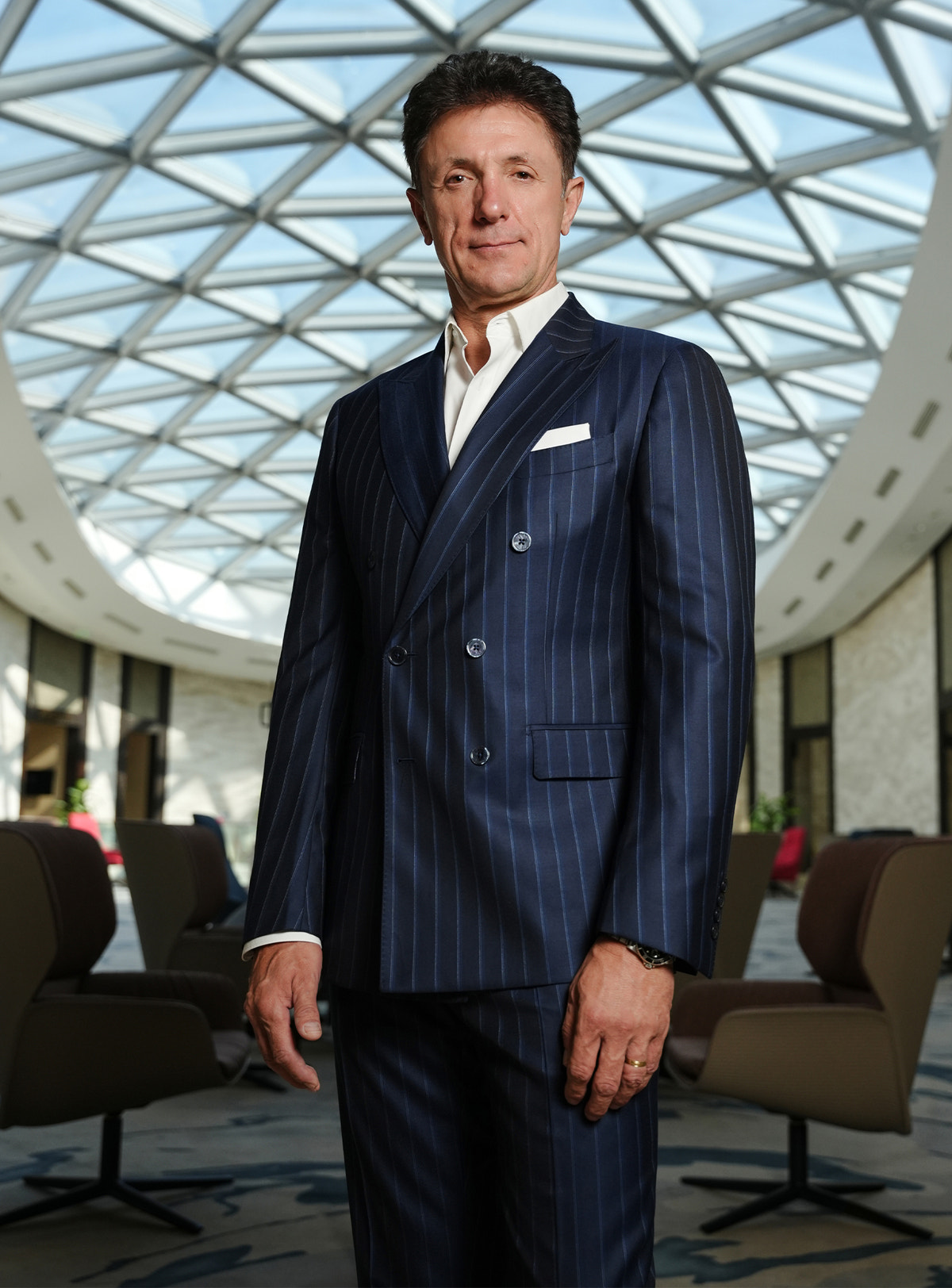 Navy pinstripe double-breasted jacket worn with a white shirt