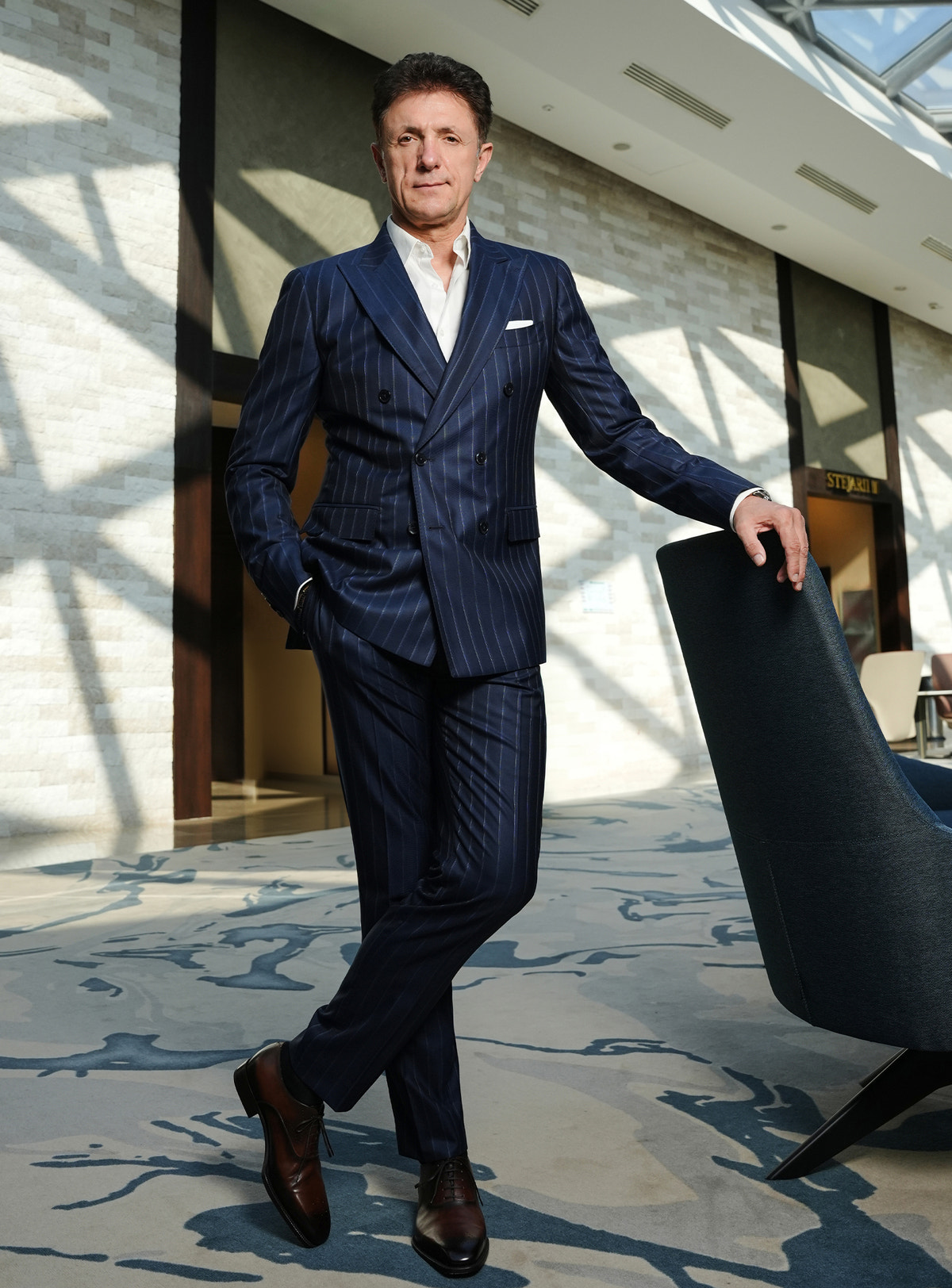 Navy pinstripe Consiglieri suit worn with brown shoes