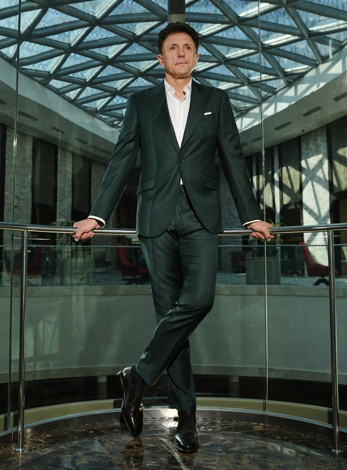 Dark green Consiglieri suit with a white shirt and black shoes