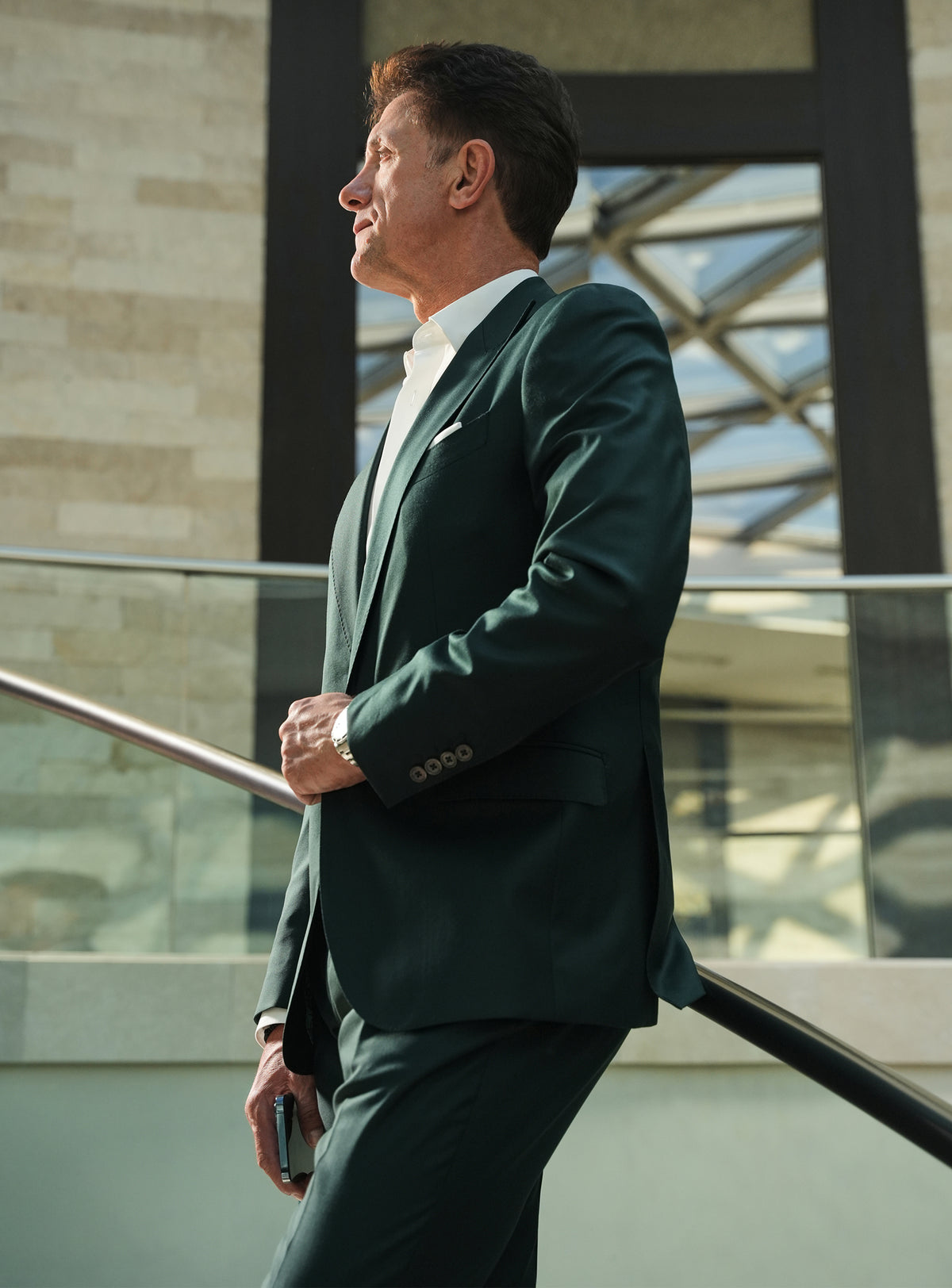 The side silhouette of a dark green Consiglieri jacket with a white shirt