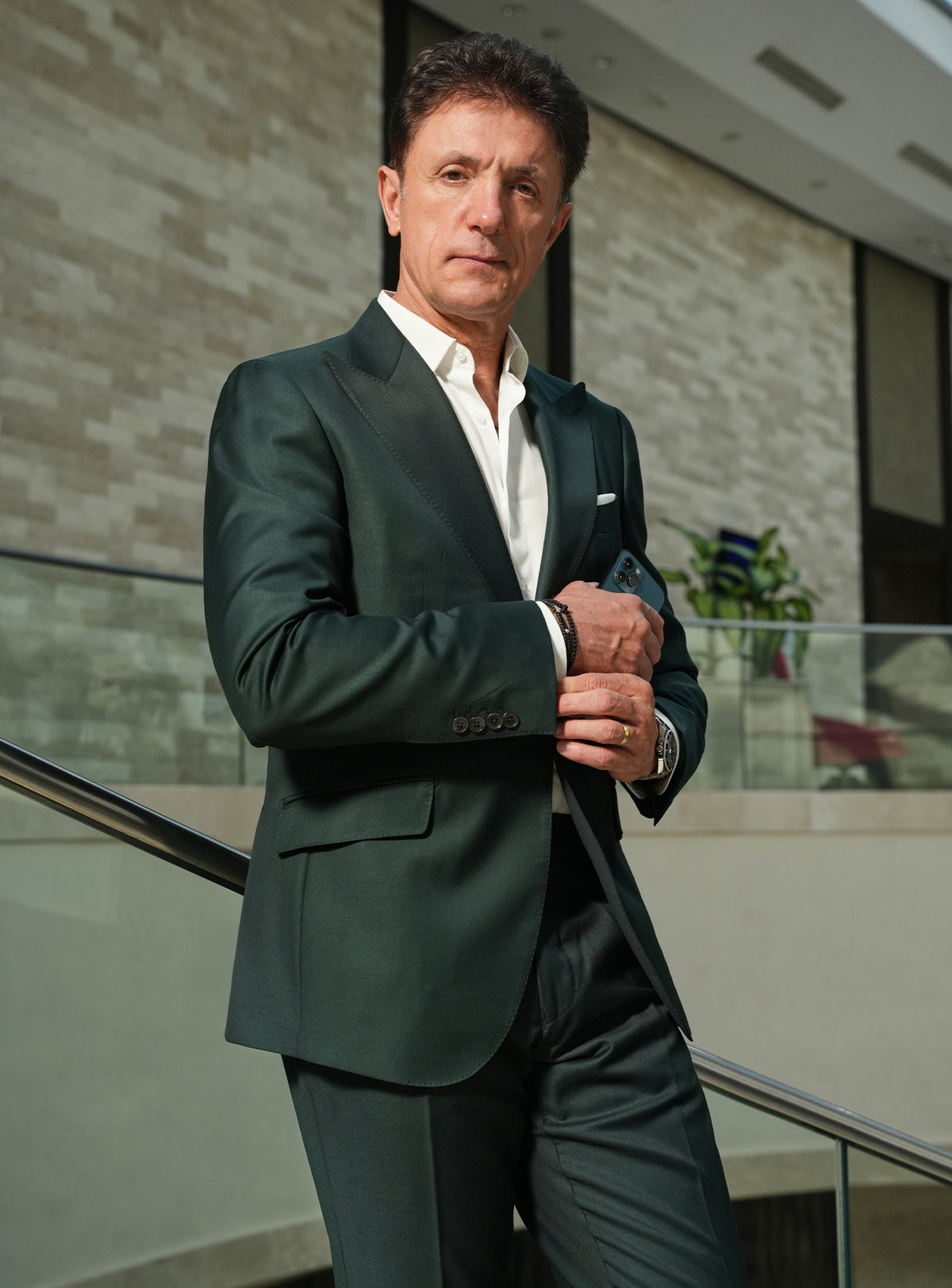 Dark green Consiglieri jacket with elongated lapels and a white pocket square