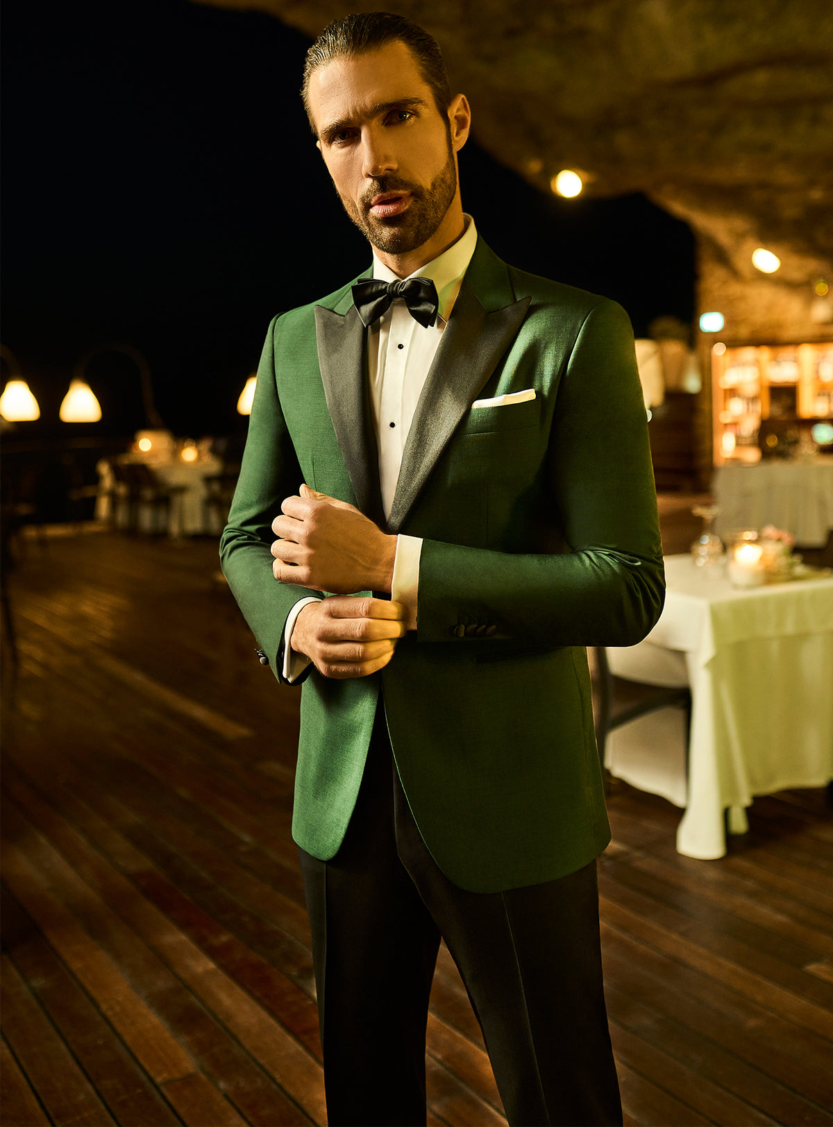 Consiglieri: emerald green tuxedo jacket with black lapels and a bow tie