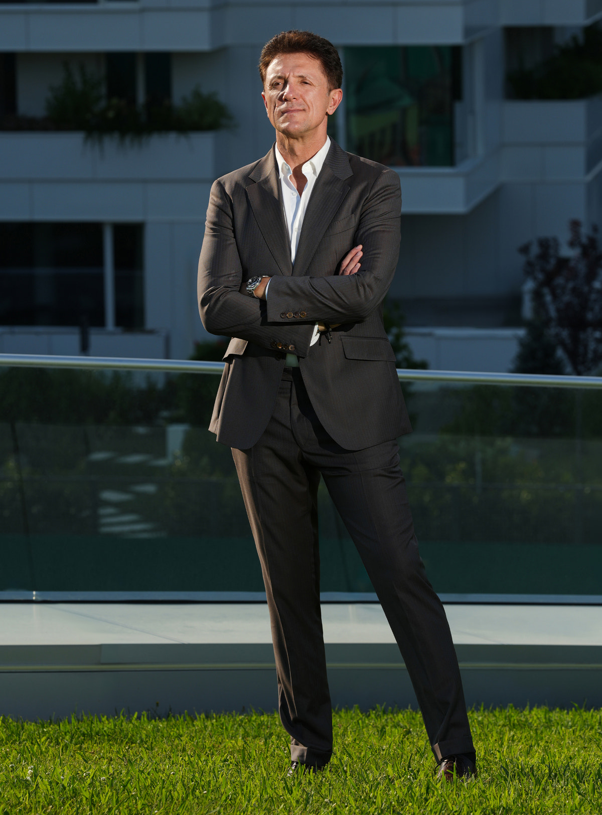 Dark-toned Consiglieri suit worn outdoors with a white shirt